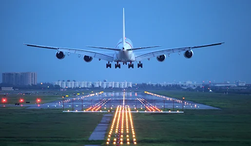 Airplane landing at Miami International Airport during dusk.